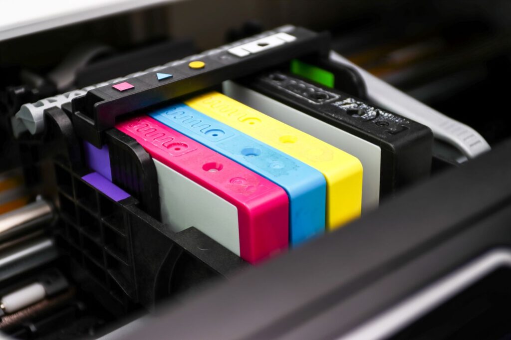 CMYK colored ink cartridges installed in an inkjet printer