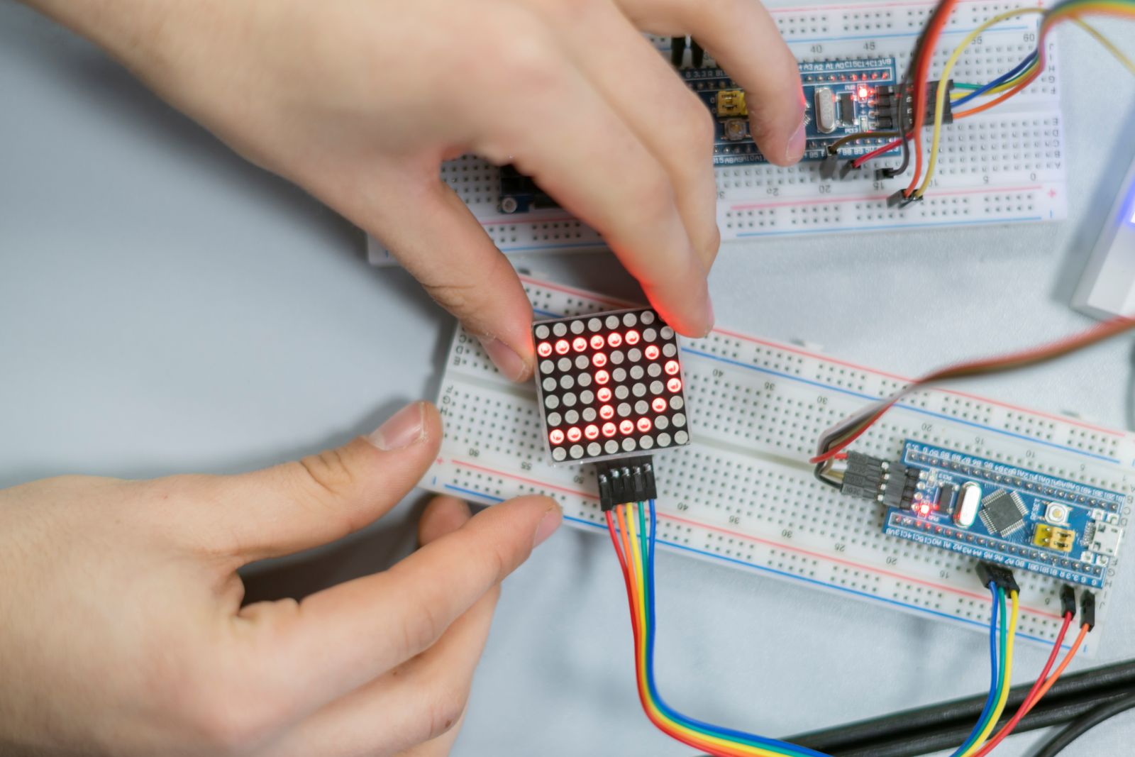 close up person work on silicon chip or microcontoller fitting a LED module