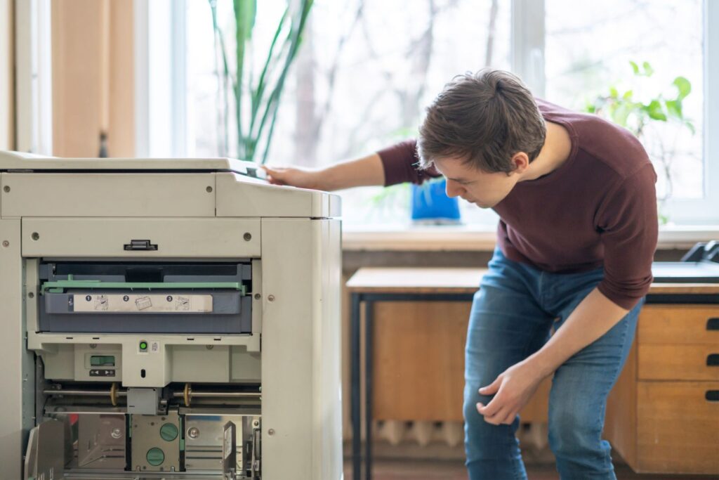 printing machine breakdown being serviced by an engineer