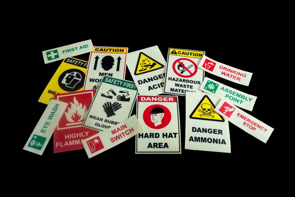 stickers of safety signs and different sizes laid out out on a table