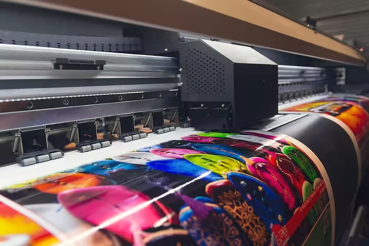 an industrial grade wide format inkjet printer reproducing a colorful acrylic photo on flex banner media at an extremely high resolution