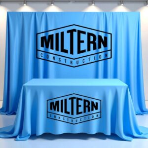 a-company-logo-printed-on-a-blue-colored-cloth-banner-draped-over-a-table-for-a-business-conference-and-a-huge-cloth-backdrop-with-the-same-logo-erected-on-a-frame-placed-behind-th1.jpg