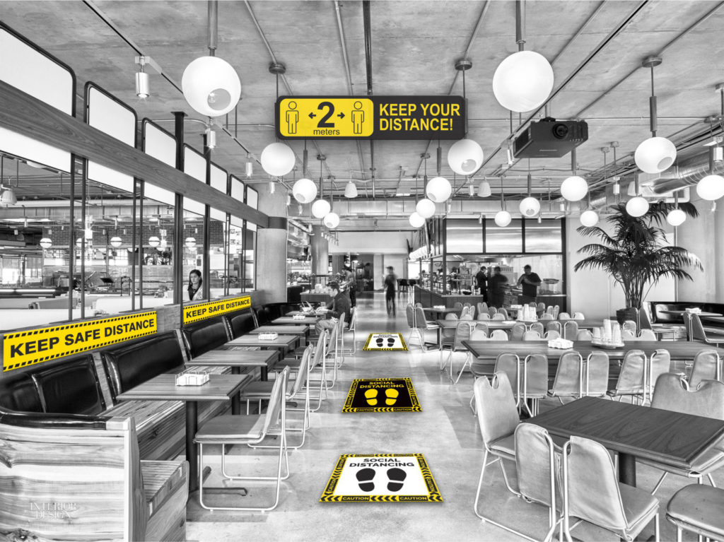 Restaurant with safety posters on the walls and social distancing floor stickers between the tables