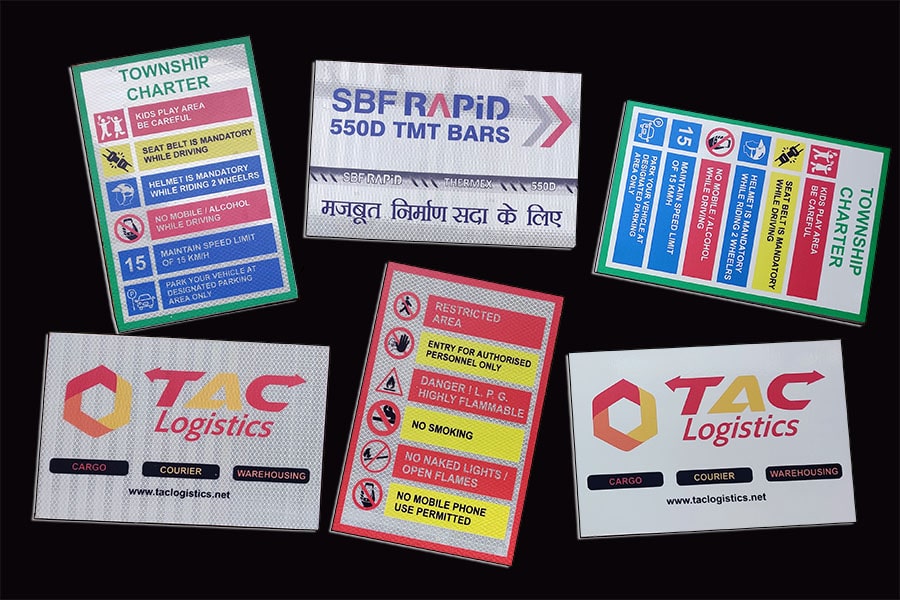 An assortment of company logo boards, road signs and advertisement prints all made from printable reflective vinyl