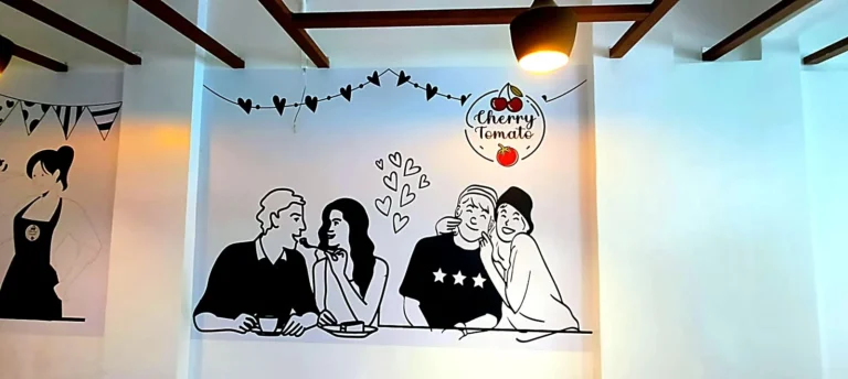 Cherry Tomato café wall: cartoon couple and the Cherry Tomato logo printed on laminated wallpaper