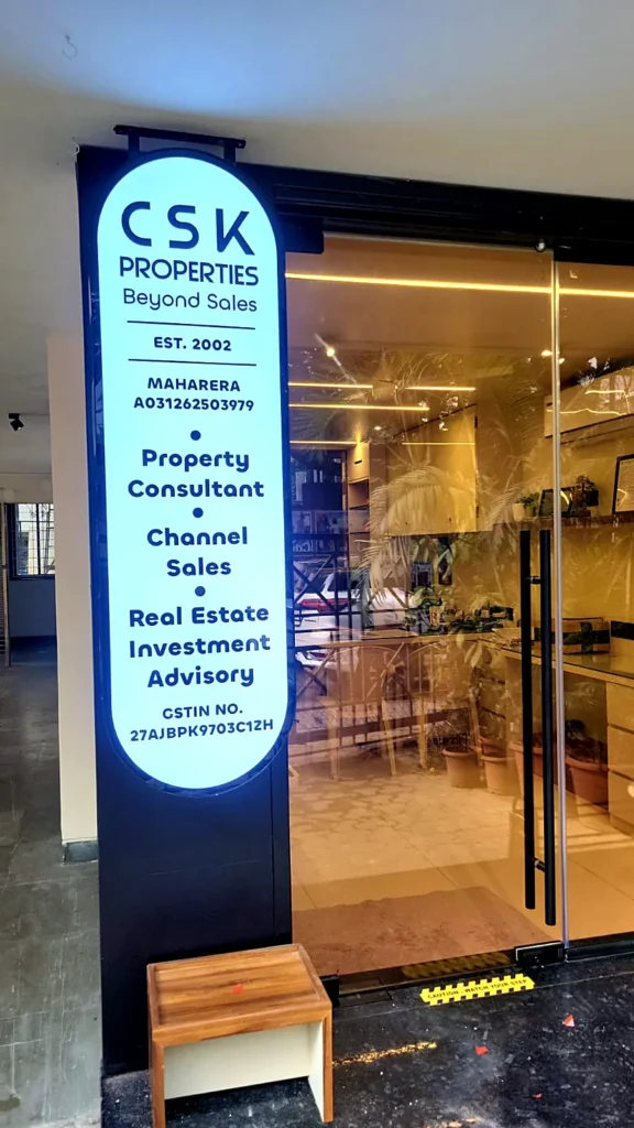 CSK Properties oval 3D LED sign glowing at the side entrance of the office