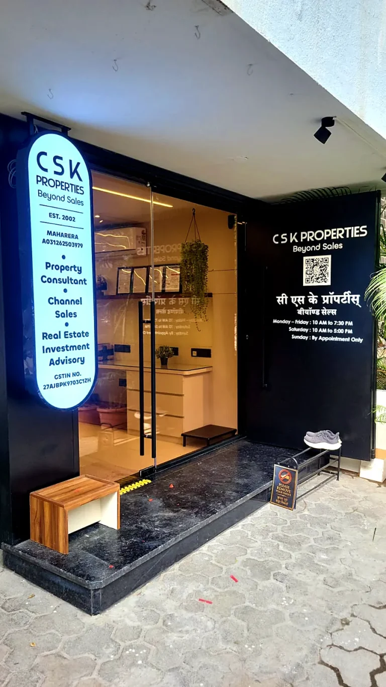The CSK Properties entrance with the oval sign and a wooden bench