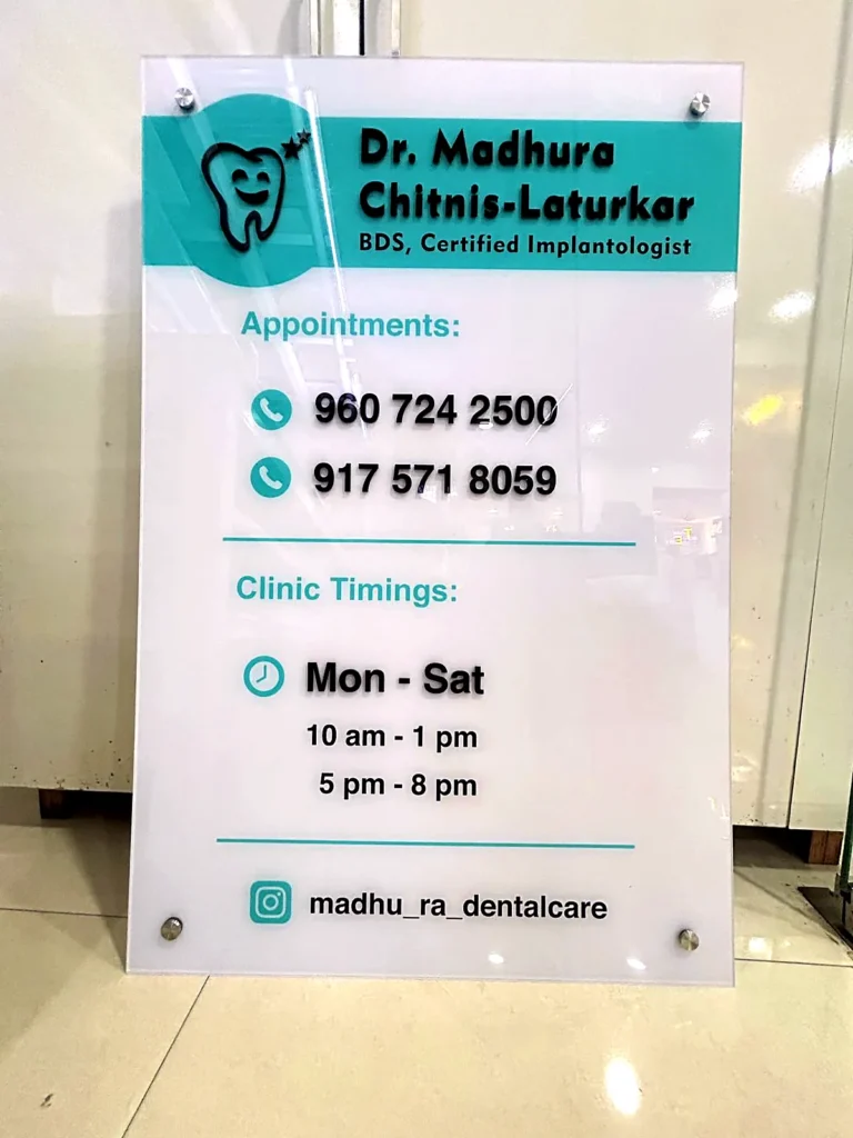 Acrylic reception board for Dr Madhura Chitnis-Laturkar’s dental clinic with timings and phone numbers
