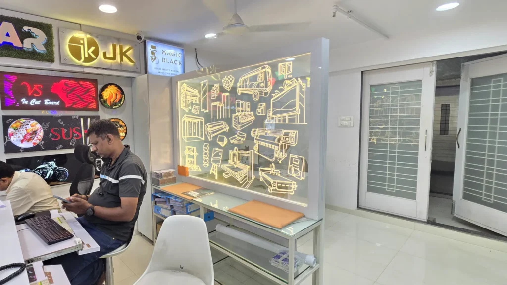 Edge-lit acrylic panel with laser-etched icons of printers, CNC machines, an ambulance and exhibition stands