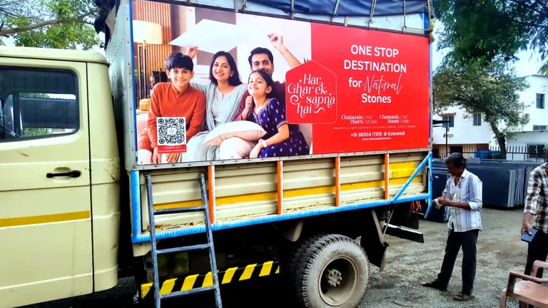 Delivery truck with a family photo print and One Stop Destination for Natural Stones panel