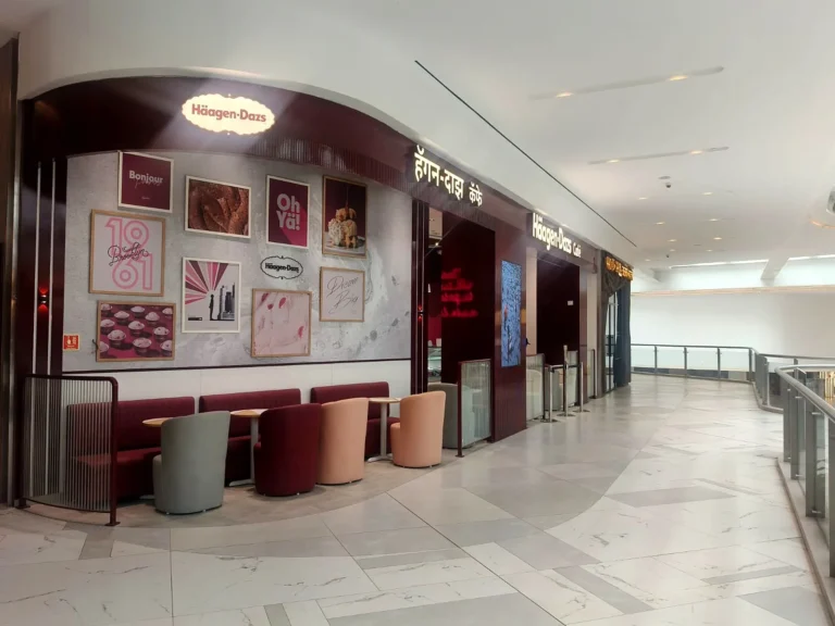 The new Häagen-Dazs café in a Borivali mall, Mumbai: lit oval logo, Marathi and English letters and the gallery wall of framed prints