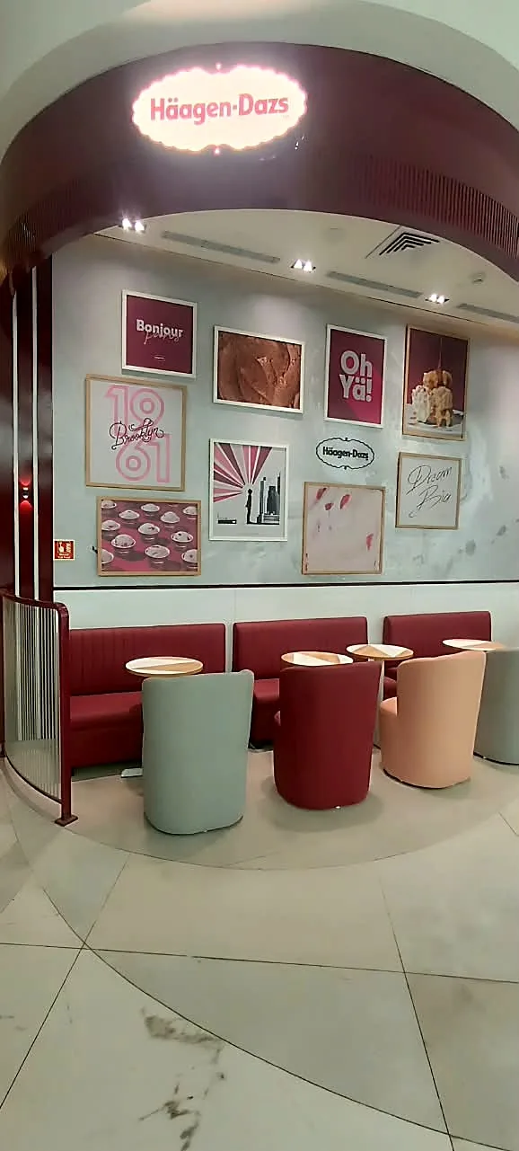 The sit-out under the lit oval logo, with the gallery wall of framed photo prints