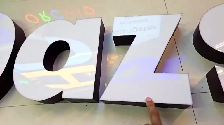 Close-up of the letters: the white acrylic faces sit flush, with no visible edge