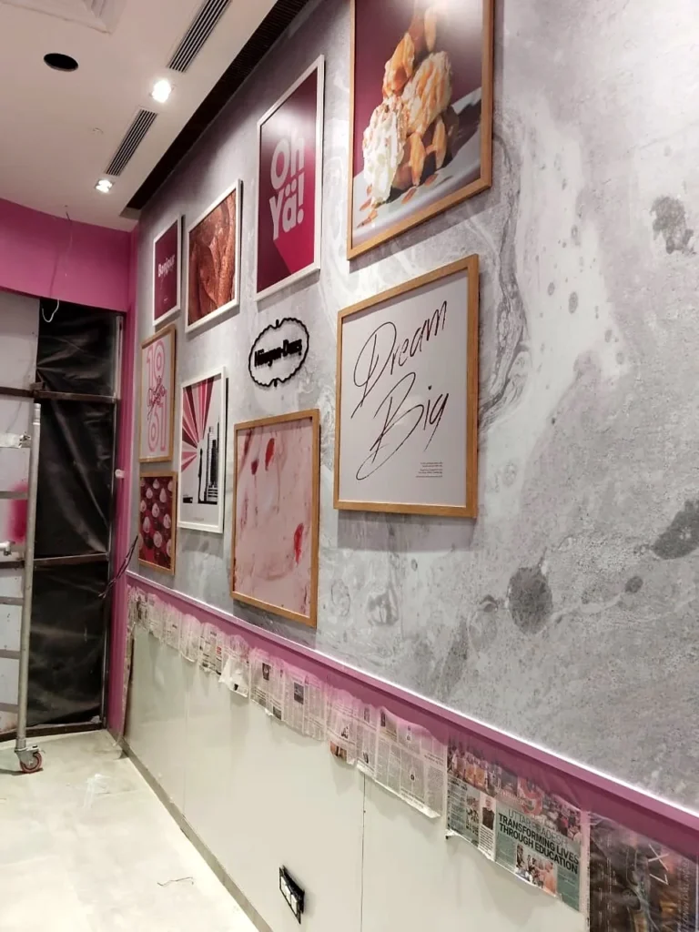 Installation night: the framed prints going up on the sit-out wall