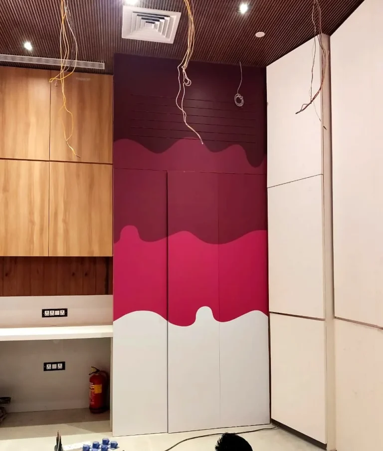 After: the cupboard doors wrapped edge to edge in printed polymeric vinyl, maroon to pink to white