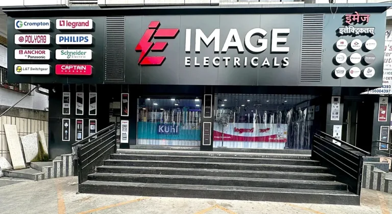 The made-over Image Electricals shop front in Wanowrie by day: one black wall, IMAGE ELECTRICALS in 3D LED letters, brand boxes left, round brand badges right