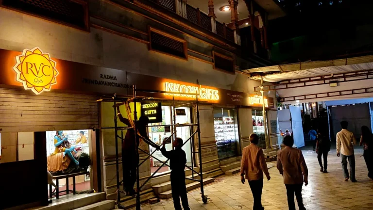 Orchid team fitting the ISKCON Gifts sign on scaffolding after shop hours