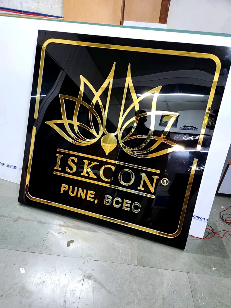 Angled view of the gold logo board showing the depth