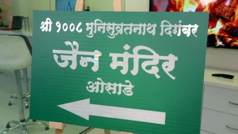 A night-reflective direction board for Shri Munisuvratnath Digambar Jain Mandir, Osade: white Marathi letters and a left arrow on green, on 3 mm ACP