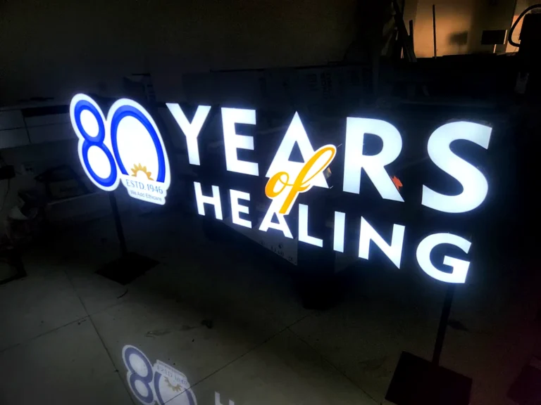 80 Years of Healing 3D LED letters glowing on a freestanding frame