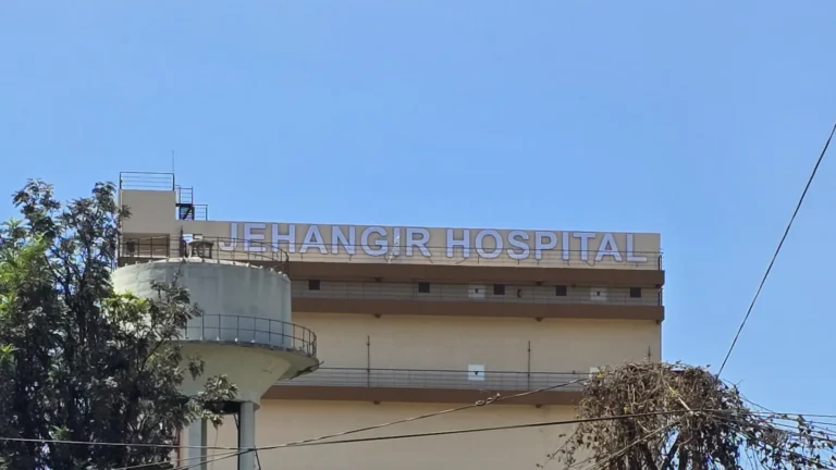 JEHANGIR HOSPITAL in 6 ft lit letters along the top of the hospital’s multi-level car park on Sassoon Road, Pune, by day