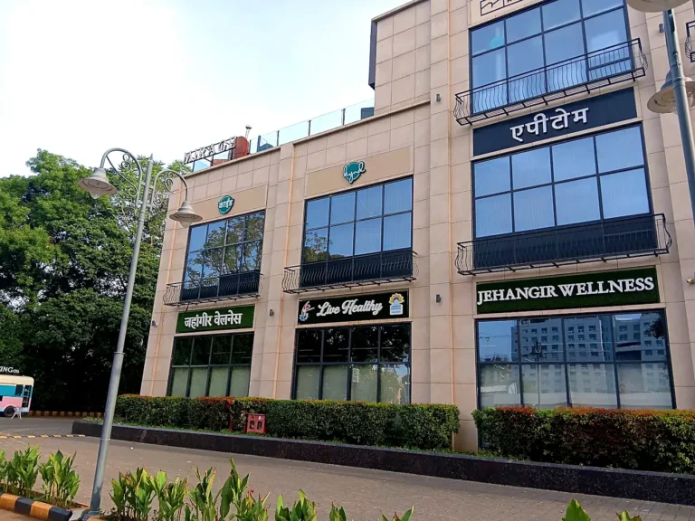 Jehangir Wellness centre frontage with grass-backed LED signboards