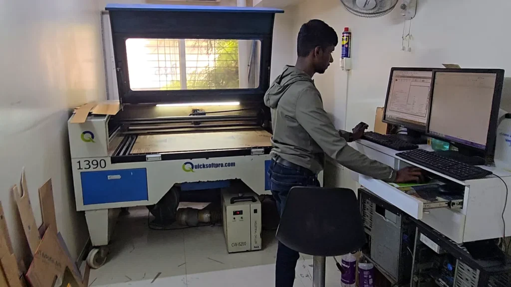 Operator at the QuickSoftPro laser cutter and engraver