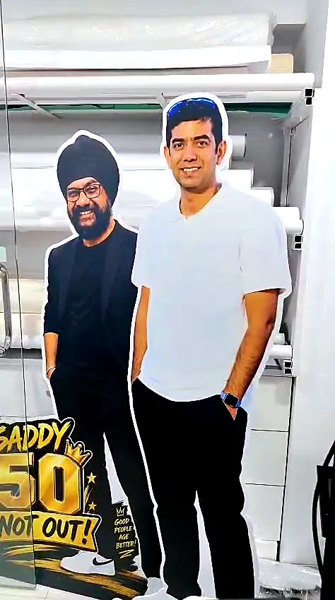 Two life-size photo cut-out standees with 50 Not Out props in the Orchid workshop