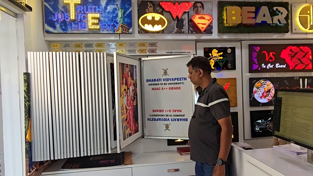 Sachin from Orchid Digitals flipping through the swing panels of printed media samples
