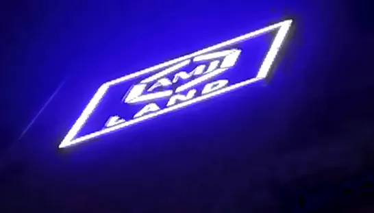 AMJ Land logo sky sign glowing blue at night on a Pune high-rise, made and installed by Orchid Digitals