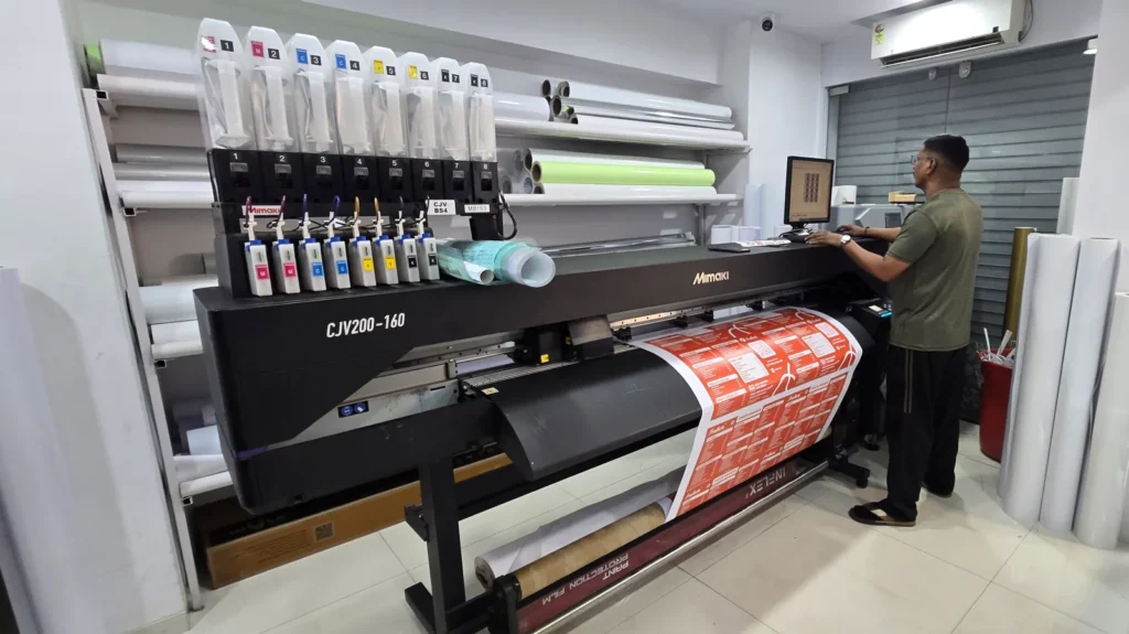 Operator at the Mimaki CJV200 print-and-cut printer