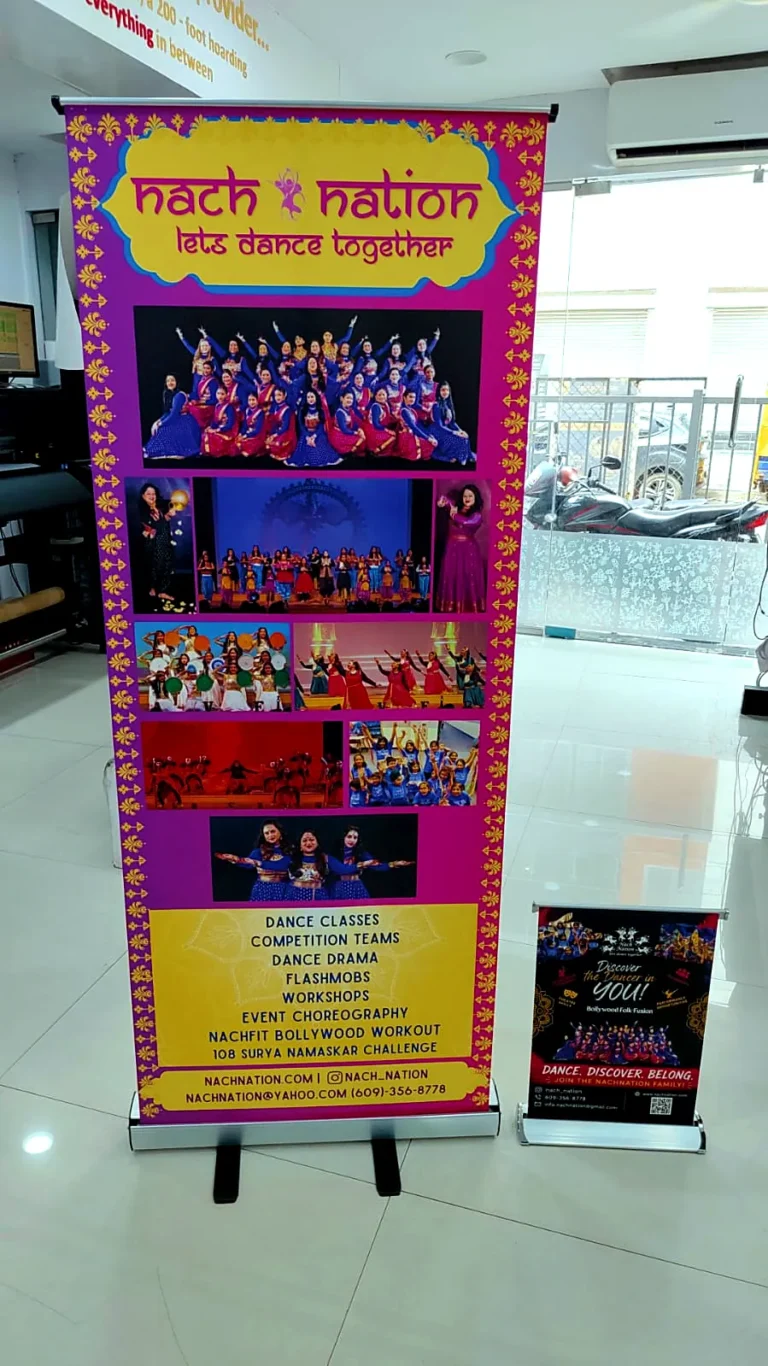 Nach Nation 5 ft roll-up standee beside a small tabletop standee