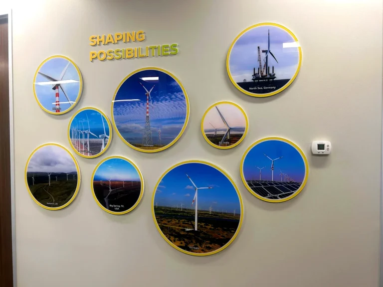 Photo wall of wind farms in round acrylic prints with yellow rims