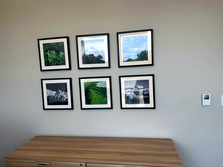 Six framed square photo prints in a cabin