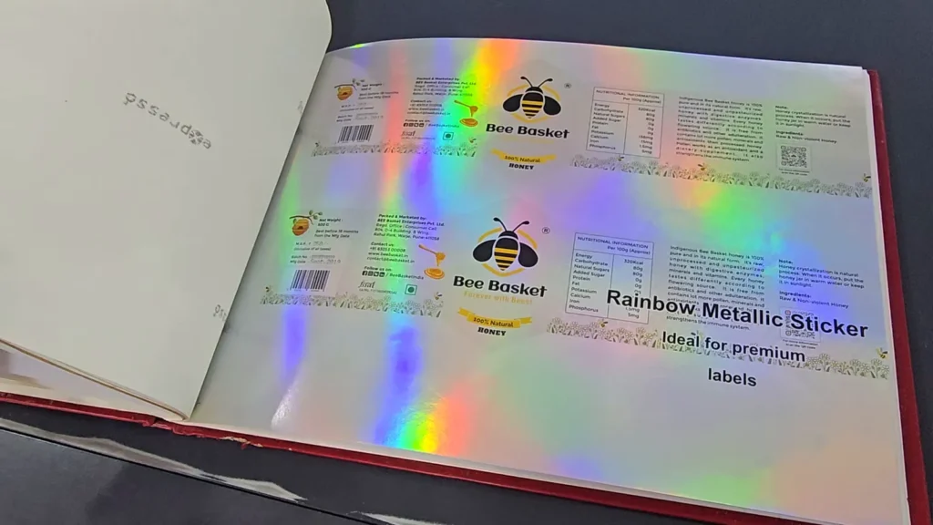 Paper sample album page: rainbow metallic stickers with a holographic-looking shine