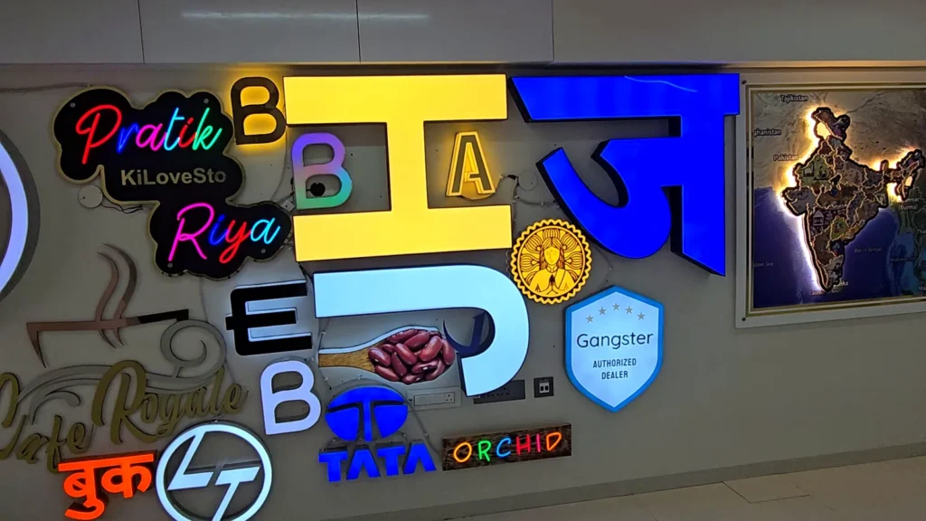 Close-up of lit acrylic letters, neon-style lettering and logos on the sample wall
