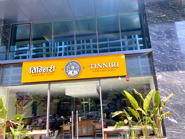 TINNIRI restaurant sign on a yellow ACP panel with raised letters and logo emblem