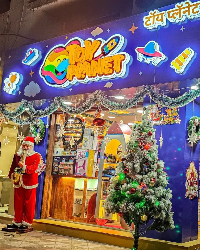 Toy Planet dressed for Christmas, the fascia glowing above the tree (photo from Toy Planet’s Google listing)
