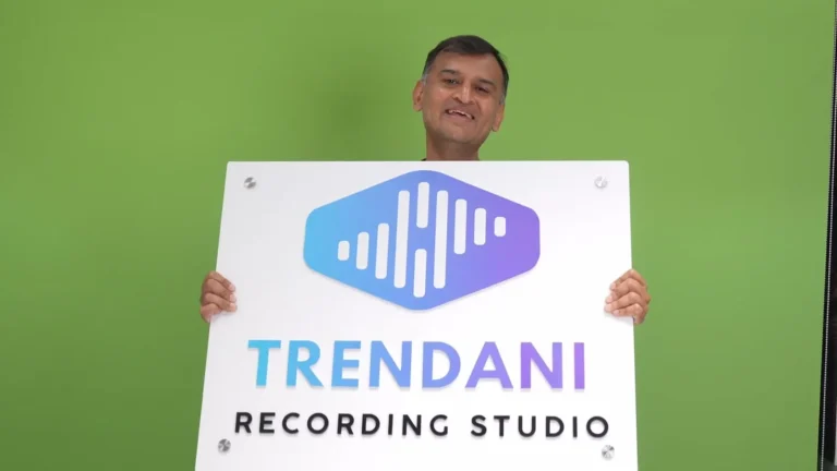 The Trendani Recording Studio board held up in our studio: a gradient logo and name raised on white acrylic, with chrome studs in the corners
